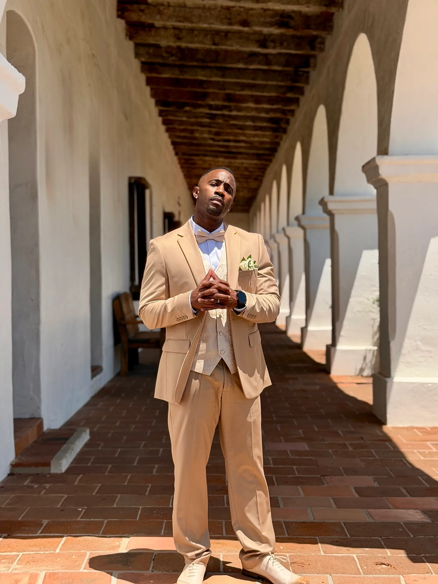 Jerome Smith, founder of FitTechGuru, sharply dressed in a sunlit colonnade.